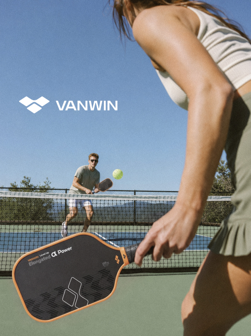 Woman holding a VANWIN Alpha Power pickleball paddle during an outdoor doubles match